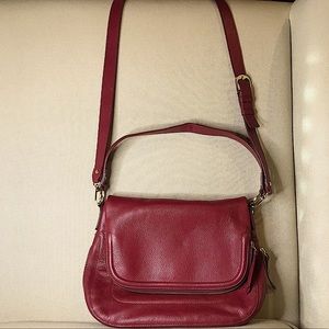 Leather wine colored Nordstrom saddle bag with shoulder strap. NEVER USED!